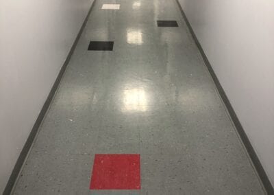 A hallway with red squares on the floor.