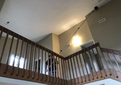 A person walking up the stairs in a house.