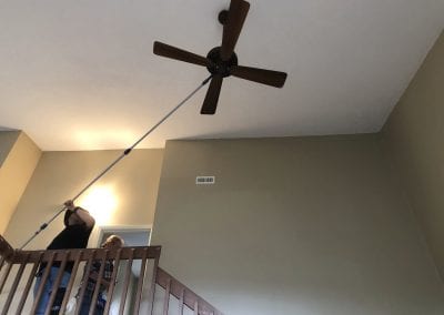 A person is hanging from the ceiling of a house