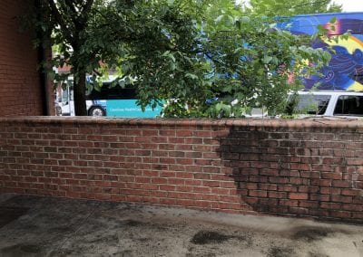 A brick wall with trees in the background