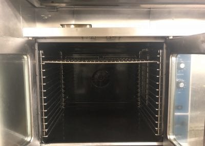 A large oven with two racks inside of it.