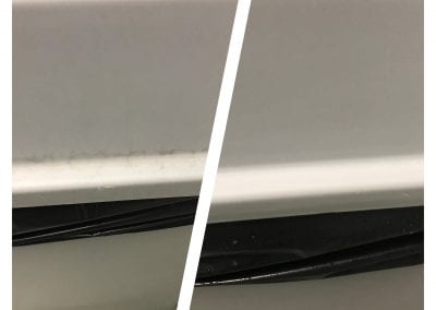 A picture of the side of a sink with a black strip.