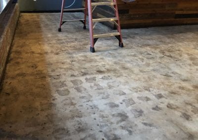 A ladder sitting on top of a hard wood floor.