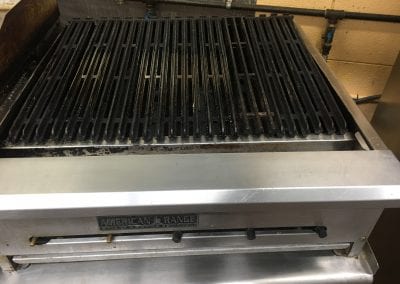 A grill that is sitting on top of the floor.
