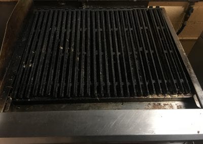 A grill that is sitting on the floor.