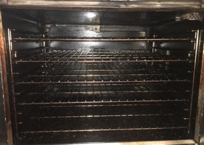 A dirty oven with no food inside it