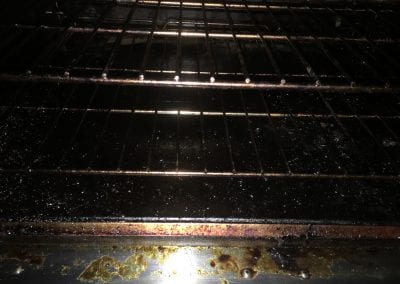 A dirty oven with some food on it